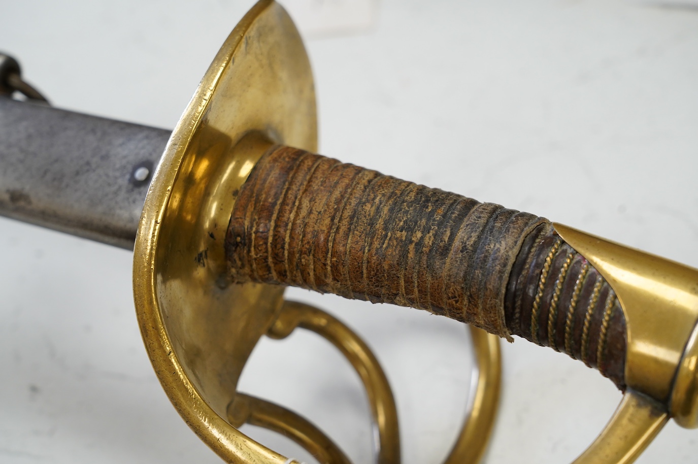 An 1854 French Curassier’s heavy cavalry trooper’s back sword with double fullered blade in its steel scabbard, blade 98cm. Condition - good